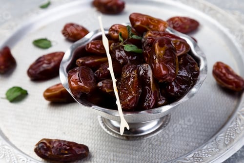 Preview: Dry fruit dates on silver tray. Copy space.
