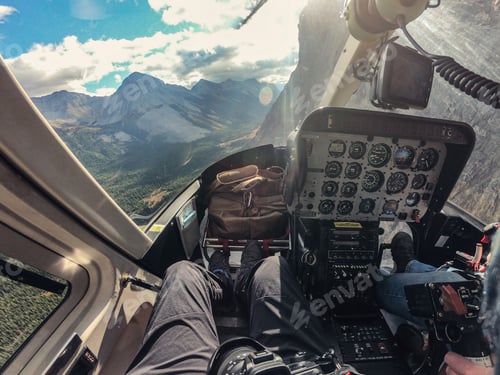 Preview: Inside of cockpit a helicopter flying over Rocky mountains in national park