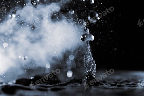 Preview: Boiling water splash with steam on black background closeup