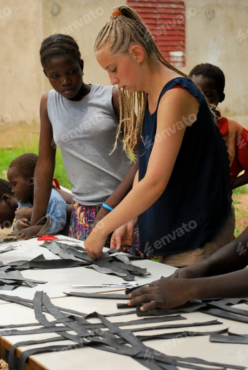 Preview: Young volunteer making baskets out of bicycle tires during recycling activity in social center