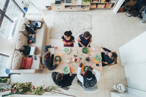 Preview: Businessmen and businesswomen celebrating at lunch party in loft office