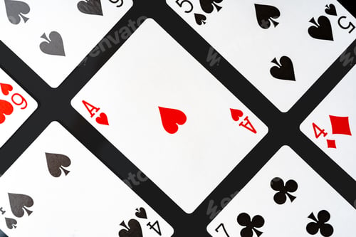 Preview: Playing cards on black background studio shot