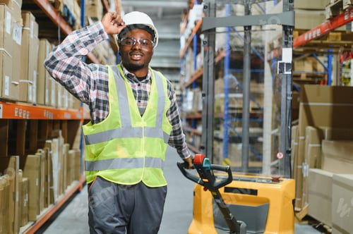 Preview: African american Man Driving Fork Lift Truck In Warehouse
