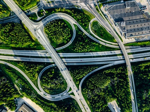 Preview: Aerial view of highway and overpass with green woods in Finland.