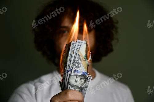 Preview: Person holding burning money