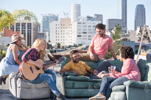 Preview: Friends having a rooftop party and playing guitar