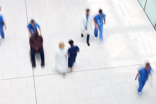 Preview: Overhead View Of Medical Staff Walking Through Lobby Of Modern Hospital Building With Motion Blur