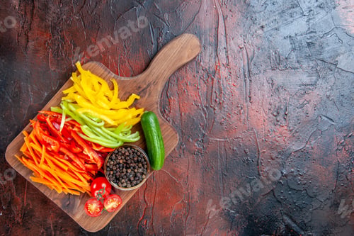 Preview: top view colorful cut peppers black pepper tomatoes cucumber on cutting board on dark red table