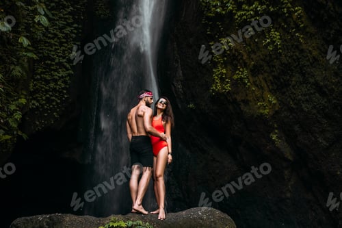 Preview: Beautiful couple at a waterfall in Indonesia. Honeymoon trip. Happy couple on the island of Bali