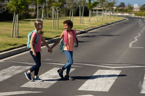 Preview: Two schoolgirls crossing the road on a pedestrian crossing