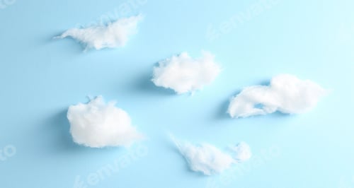 Preview: Clouds made of tasty white cotton candy on light blue background, flat lay