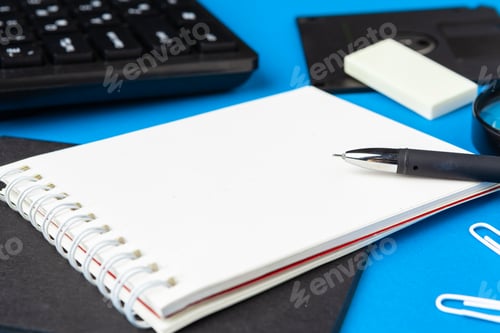 Preview: Flat lay, top view of blue office table desk. Workspace with blank note book, office supplies