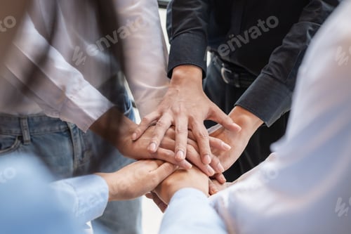Preview: Group of business people putting their hands working together on wooden background in office. group