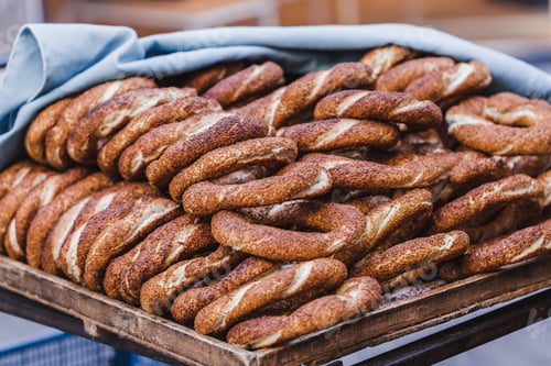 Preview: Turkish bagel simit close up. Fresh baked pastries for sale on the streets