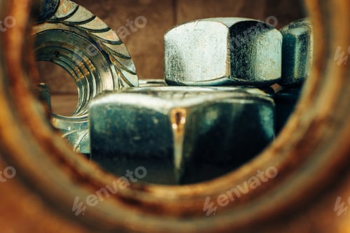 Preview: Macro shot of metal nuts on textured surface