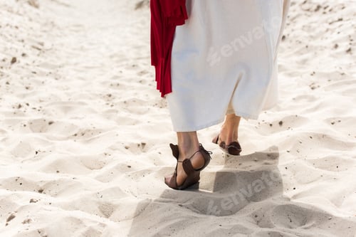 Preview: cropped image of Jesus in robe, sandals and red sash walking on sand in desert
