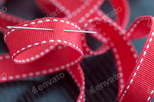 Preview: Needle in a red ribbon, closeup