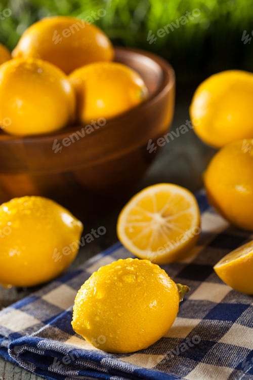 Bright Yellow Lemons in Wooden Bowl on Table