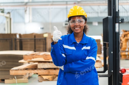 Preview: Portrait female professional engineer factory in protective uniform operating machine