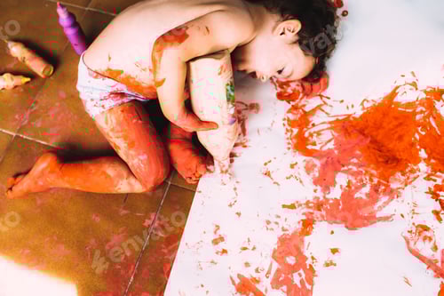 Preview: One year old girl enjoys getting dirty with paint and making a mess of it.