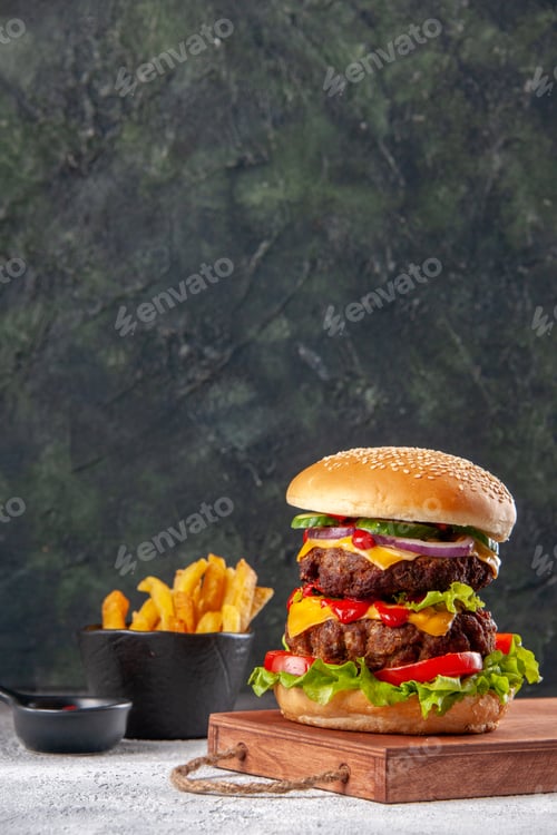 Preview: Tasty sandwich on wooden cutting board fries on blurred background