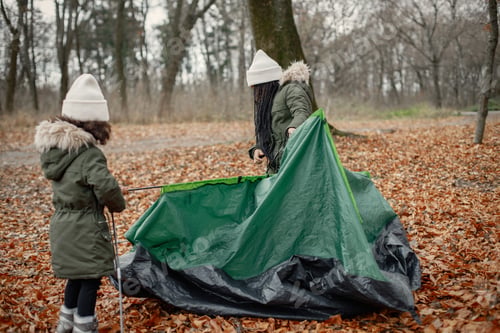 Preview: Two little black sisters in tent camping in the autumn forest