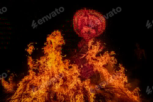 Preview: Man performing theyyam ritual form of dance worship surrounded b