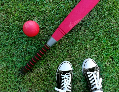 Preview: Baseball bat and ball on the grass, sneakers