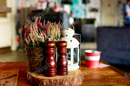 Preview: Wooden traditional salt and pepper shakers in cafe,selective focus.Still life details of cozy