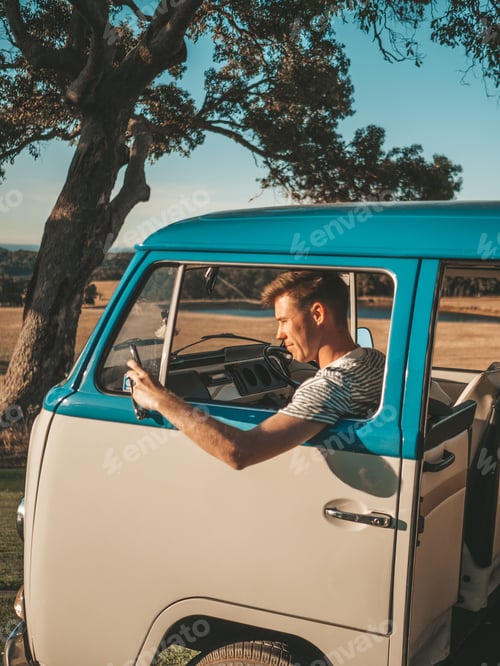 Preview: Vertical shot of a young Caucasian male driving a van