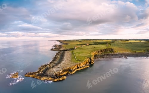 Preview: View from above on Embleton bay and green agricultural fields at Sunset. England countryside. UK