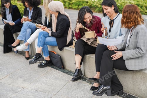 Preview: Multiethnic business women doing lunch break outdoor from office building - Focus on asian girl hand