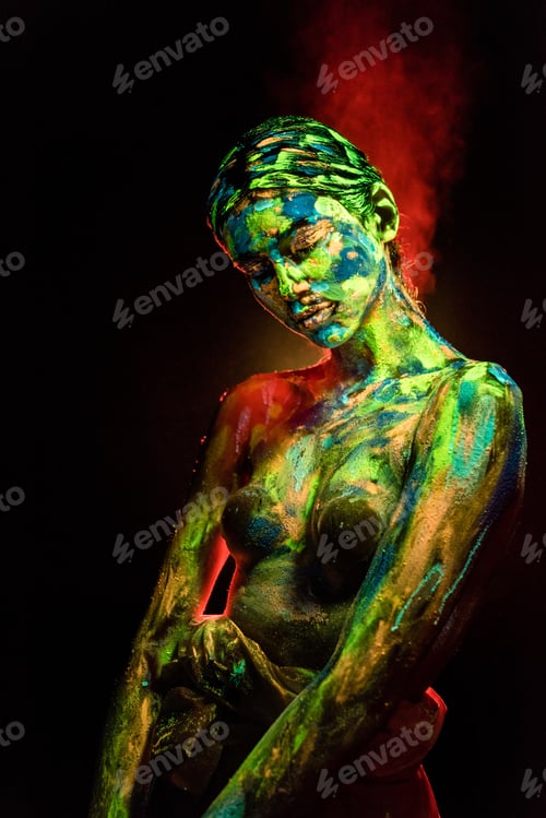 Preview: portrait of beautiful woman with colorful ultraviolet paints on body on black backdrop