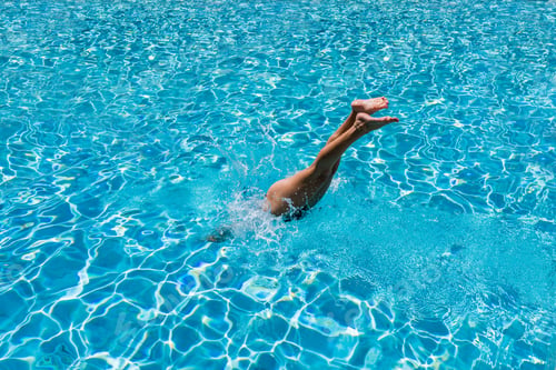 Preview: woman in luxury spa resort near the swimming pool.