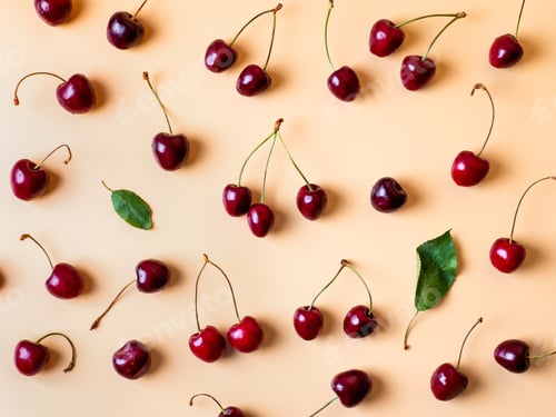 Preview: Fresh cherries scattered on yellow background