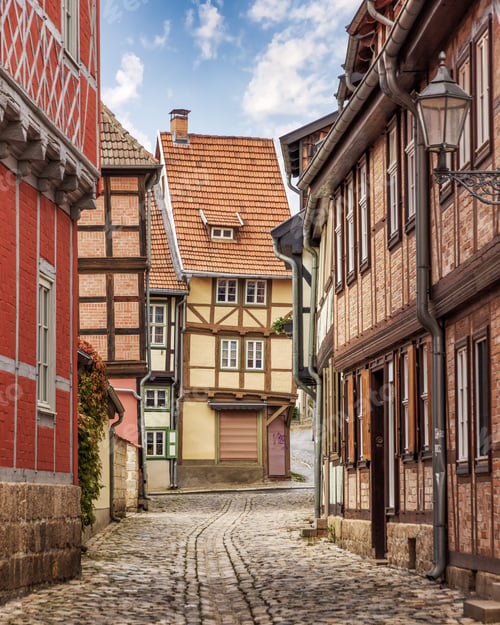 Preview: small cobblestone streets in europe with old buildings and lamps