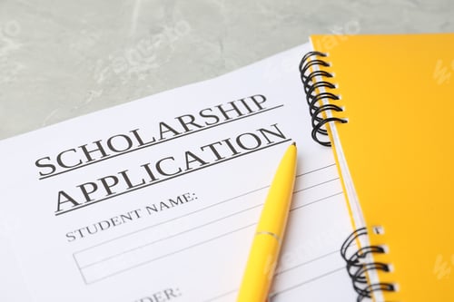 Preview: Scholarship application form, notebooks and pen on grey marble table, closeup