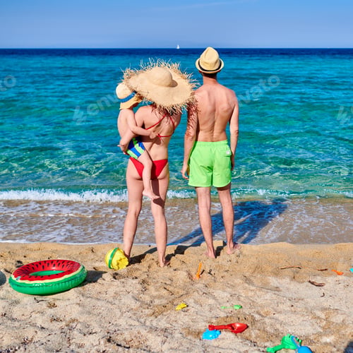 Preview: Family On Beach With Inflatable Ring And Toys. Young Couple With Three Year Old Boy. Summer Family