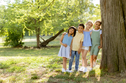 Preview: Group of asian and caucasian kids having fun in the park
