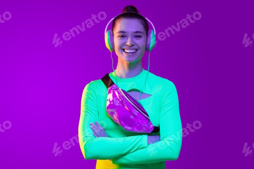 Preview: Happy smiling girl listening to favorite music tracks in headphones