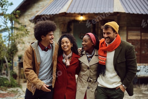 Preview: Multiracial group of happy friends talking and having fun during winter holidays.
