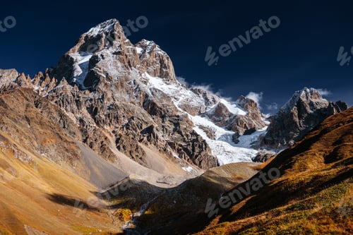 Preview: Autumn landscape and snow mountains in beautiful cumulus clouds. Main Caucasian Ridge. Type Mount