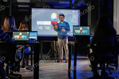 Preview: Design tools. Male business trainer is against projector with data, teaching people