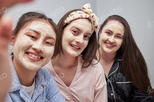 Preview: Friends, women and sleepover with mask, selfie and bonding with cosmetics, smile and quality time.