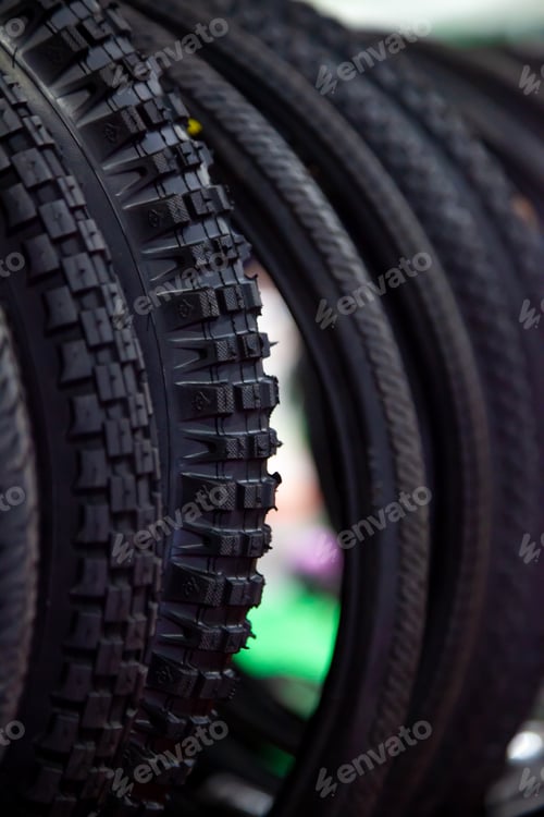 Preview: Bicycle tires in close-up. Tire texture. Black background.
