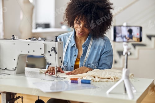Preview: African-American seamstress sews clothes shooting video for blog in studio