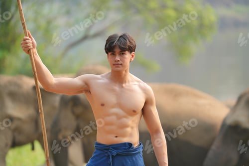 Preview: Asian elephants in the park with young man