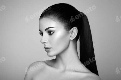 Preview: Elegant Woman with Dark Ponytail Posing in Studio