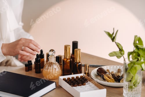 Preview: Close-up of a Woman's hands applying essential oil on her wrist indoors