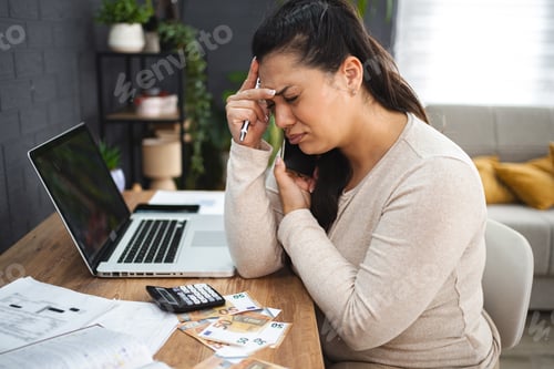 Preview: Frustrated woman doing home finances